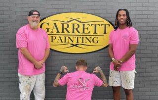 Garrett Painting interior house painting team members Jared Allen, Tyler Russell and Jaivon McDaniel in pink shirts