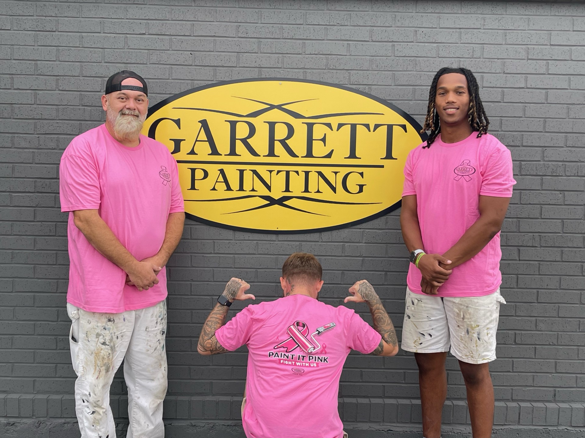 Garrett Painting interior house painting team members Jared Allen, Tyler Russell and Jaivon McDaniel in pink shirts